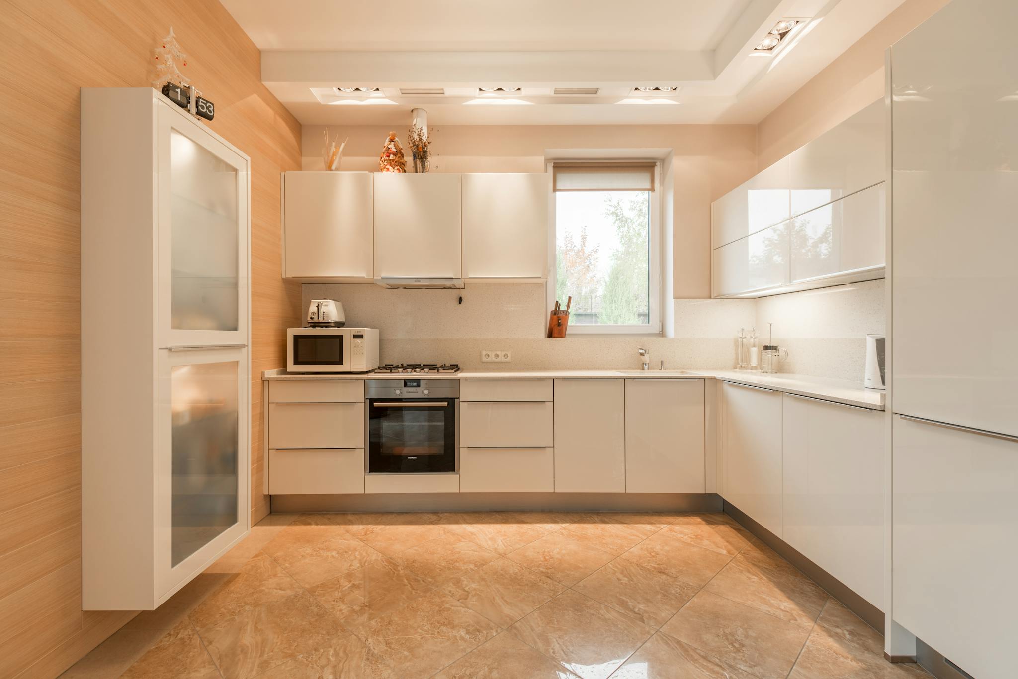 stylish interior of kitchen with white cupboards