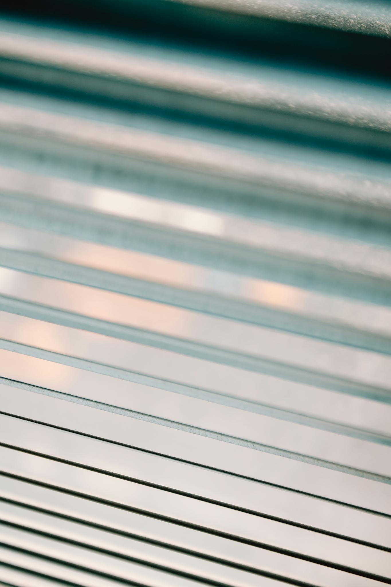 closeup of half closed white metal blinds